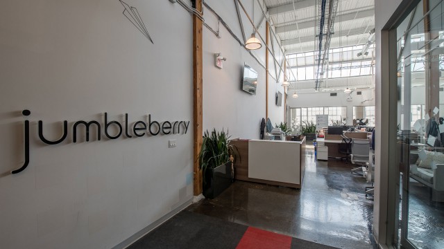 Jumbleberry's logo on a brick wall